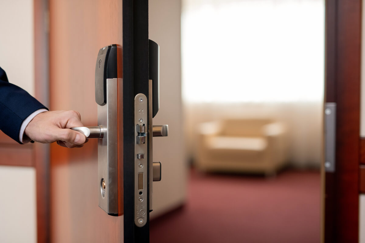 human-hand-holding-handle-of-wooden-door-while-KJMHLVS