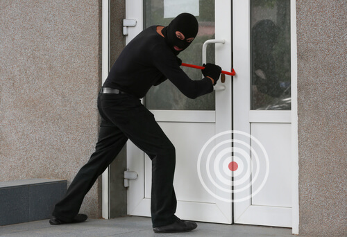 Armed thief breaking a door