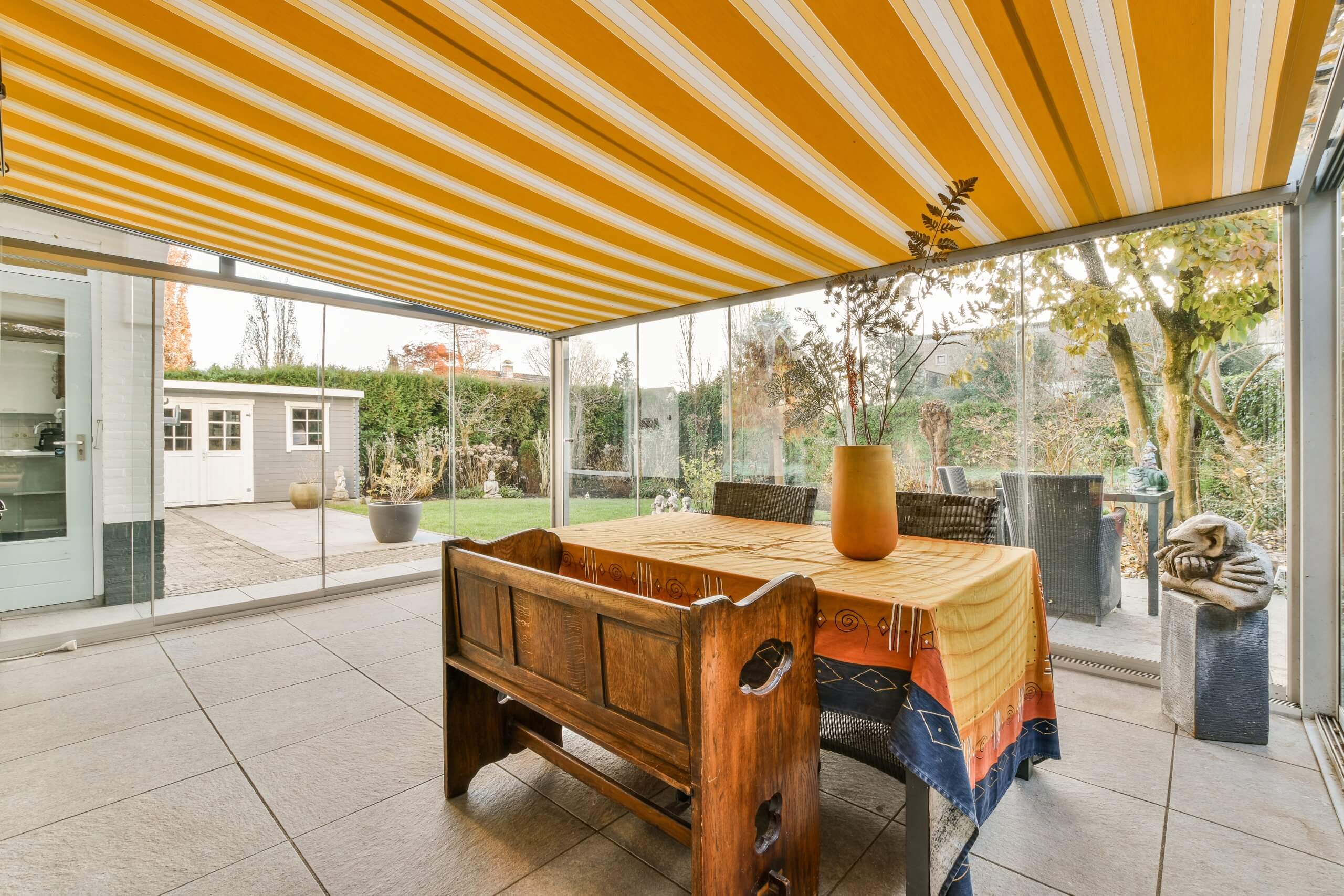 a dining area with a table and a glass patio